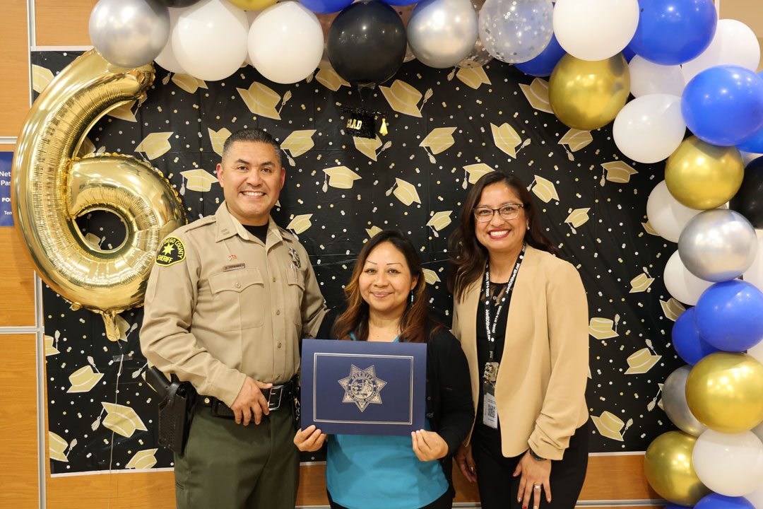 Deputy and student holding a certificate