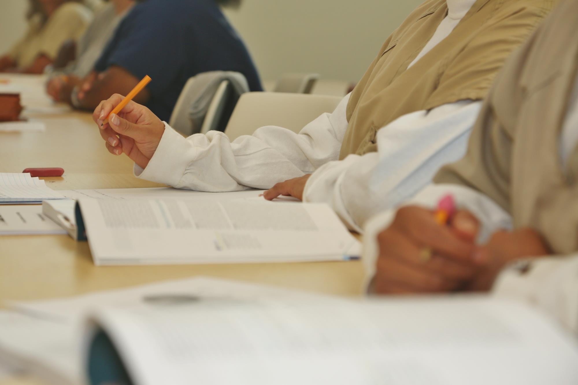 Students arms with books open