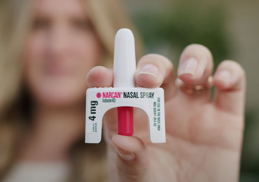 Woman holding a Naloxone box